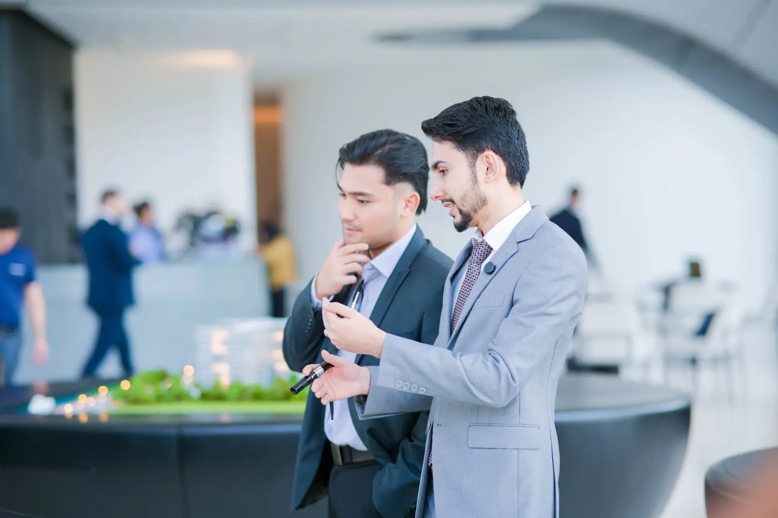 Two colleagues reviewing printed market charts at a desk