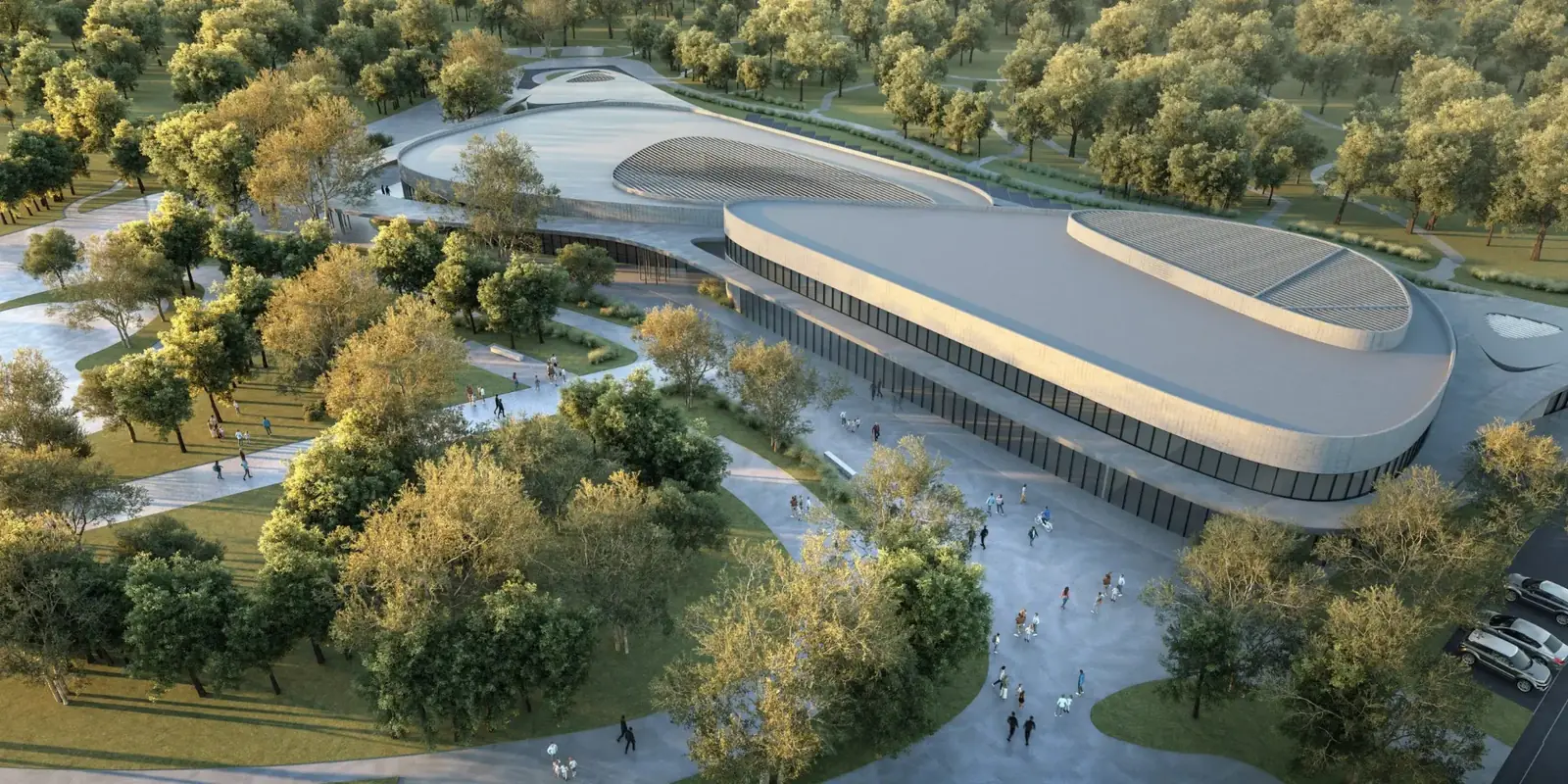Aerial view of a curved community pavilion set within the woodland of Masaar, Sharjah