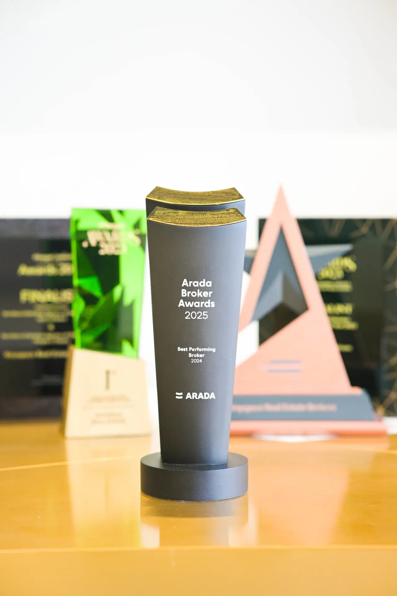 A glass and gold award plaque resting on a table
