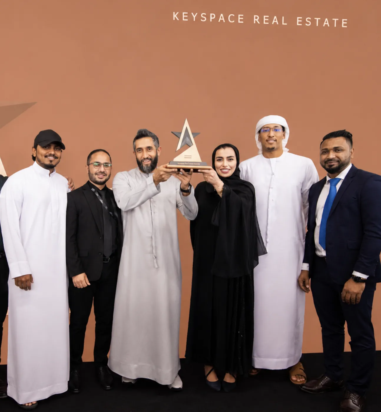 The Keyspace Real Estate team holding their Alef top seller award on stage