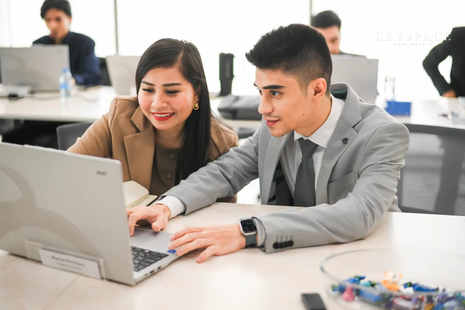Two Keyspace colleagues reviewing a listing together at a desk
