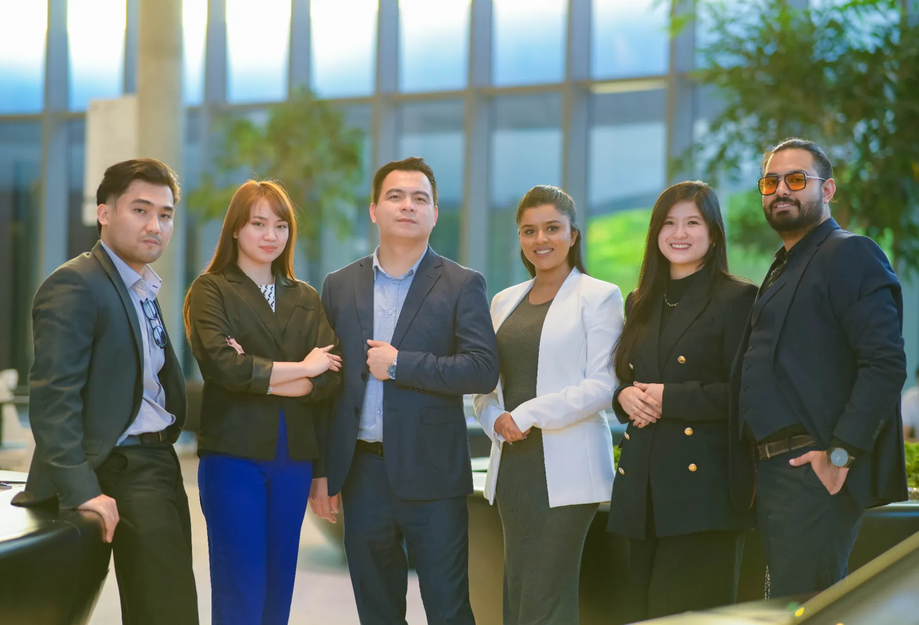 Six Keyspace colleagues standing together in the office lobby