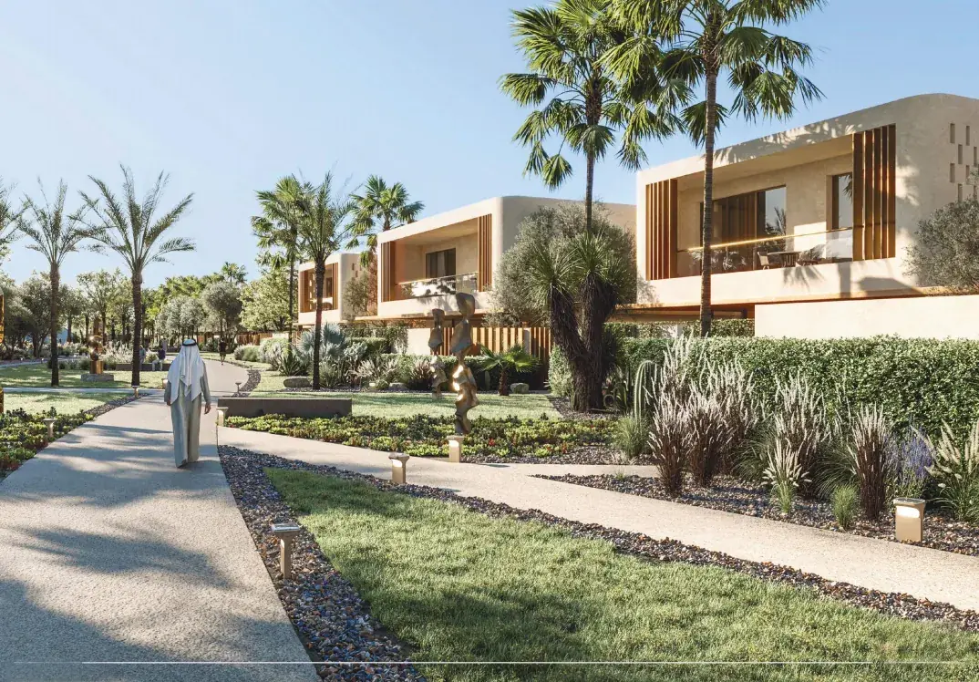 Landscaped garden walkway beside contemporary stone villas in Al Tay Hills, Sharjah